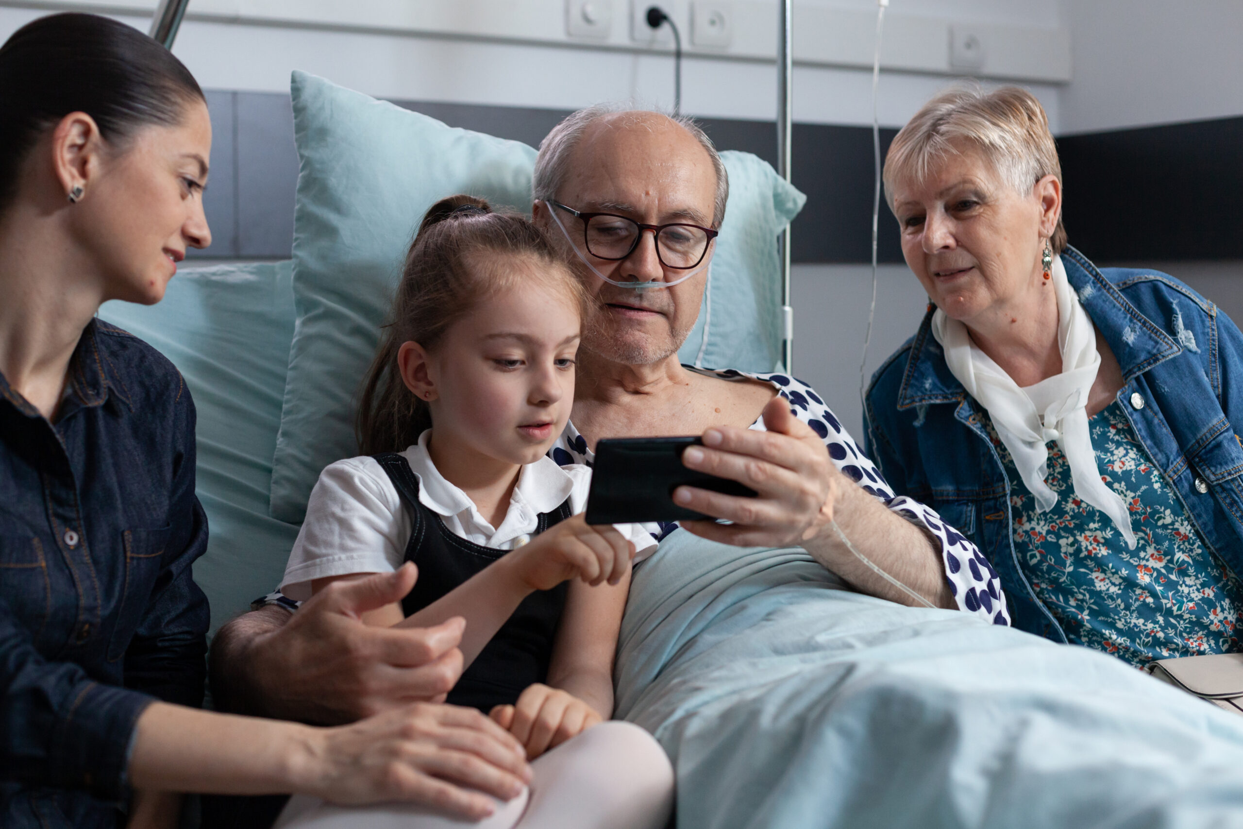 Sick man relatives showing pictures on smartphone